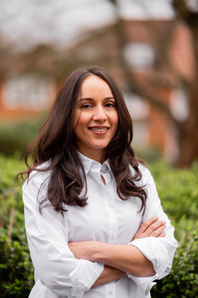 Angeli Degardin wearing a white top standing outside